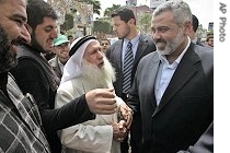 Palestinian PM Ismail Haniyeh, right, greets supporters in Khan Younis refugee camp in southern Gaza Strip, April 7, 2006